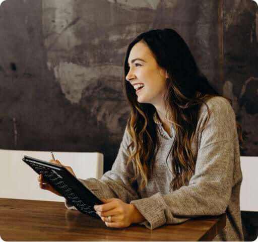 Woman using a tablet smiling